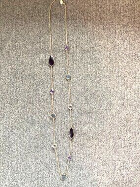 Loft - Gold chain with purple/gray stone details.